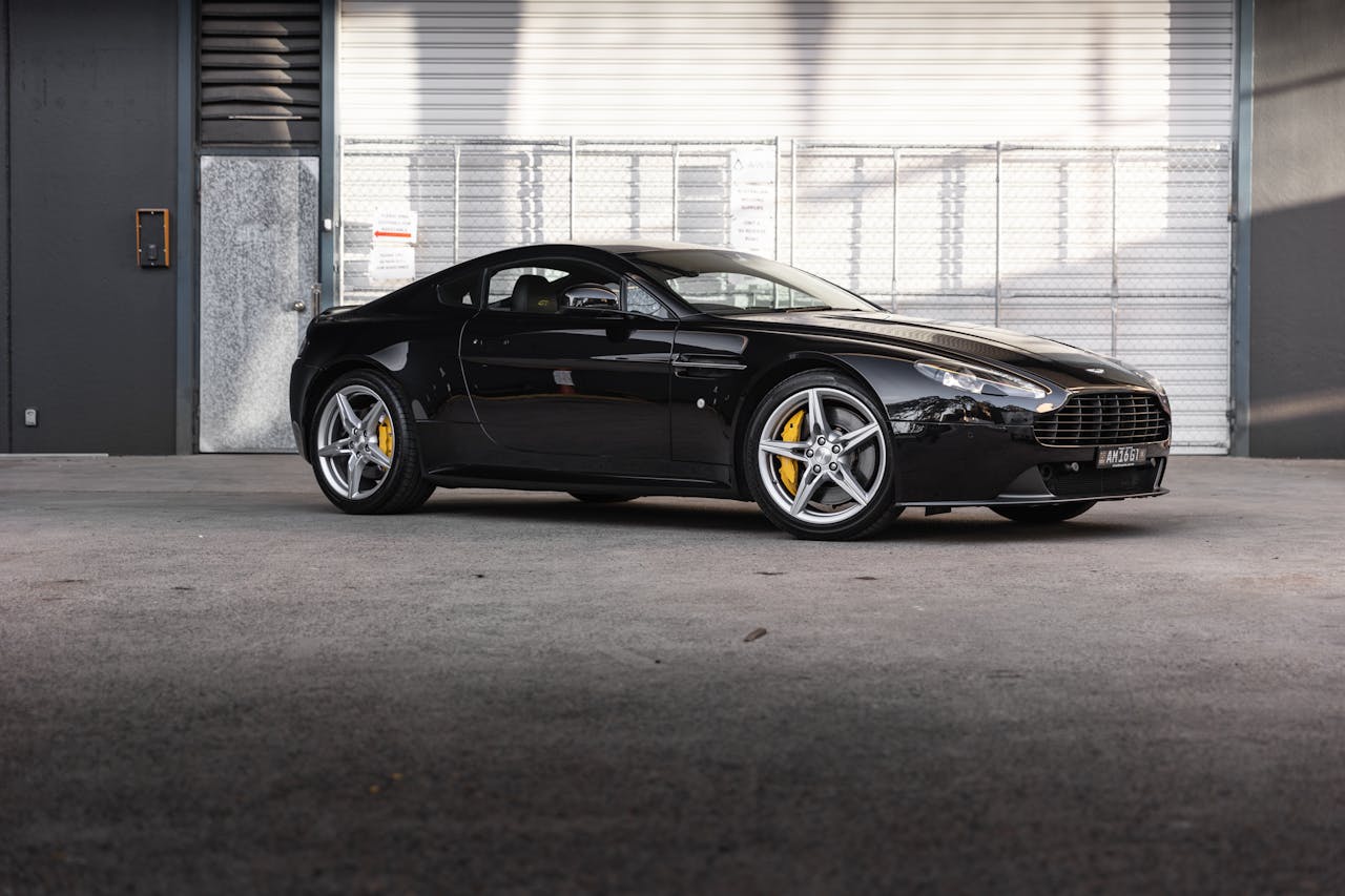 Black Aston Martin V8 Vantage parked outdoors in Sydney, showcasing luxury automotive design.
